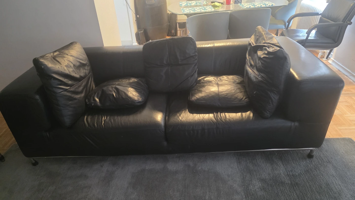 Black Leather Sectional Sofa with Pillows