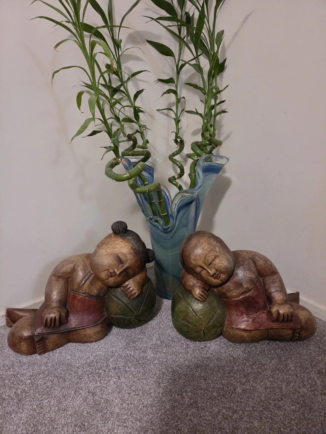 Carved Wooden Sleeping Figures with Lucky Bamboo