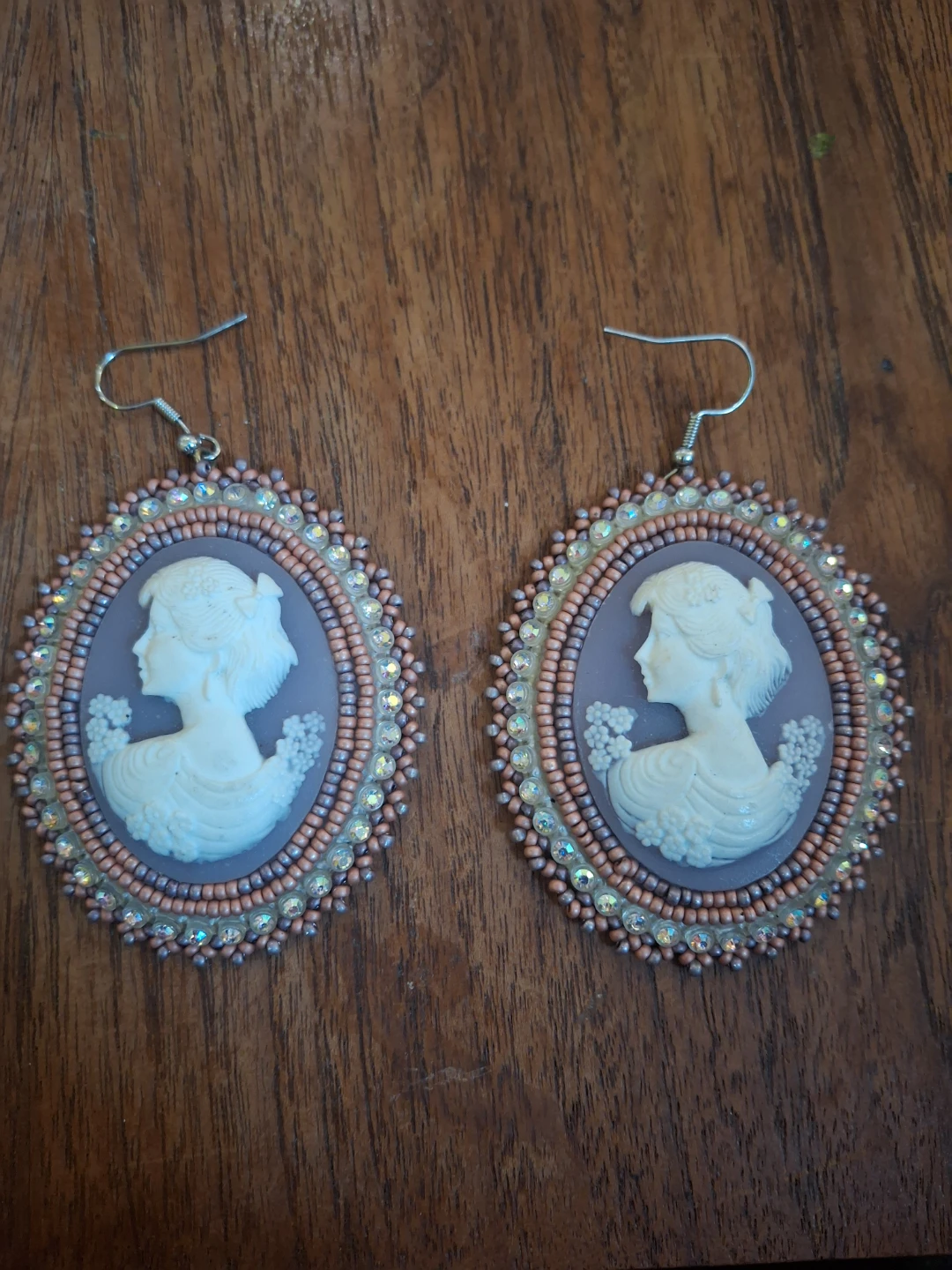 Handmade beaded cameo earings with leather back.