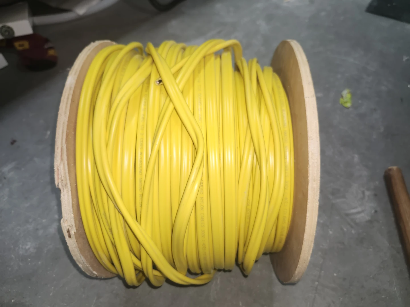 Yellow Electrical Wire on Wooden Spool