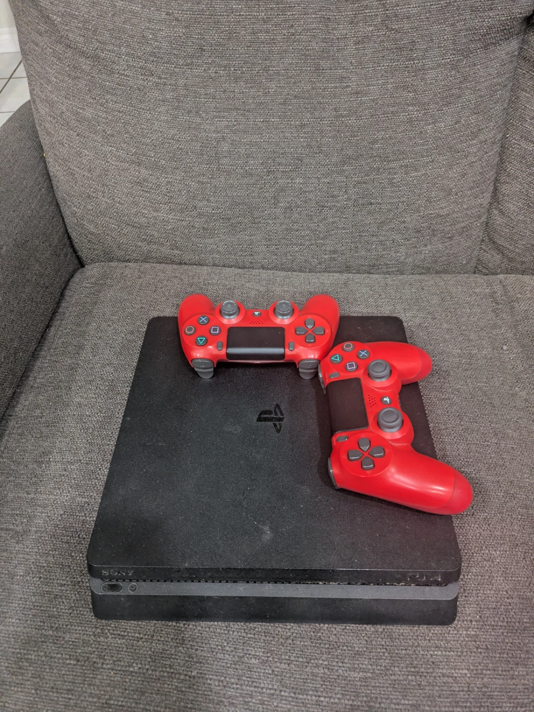 Sony PlayStation 4 slim Console with 2 Red Controllers