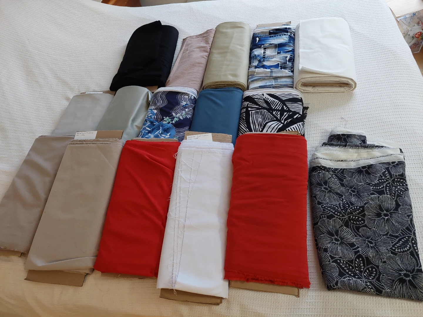Rolls of assorted fabrics.