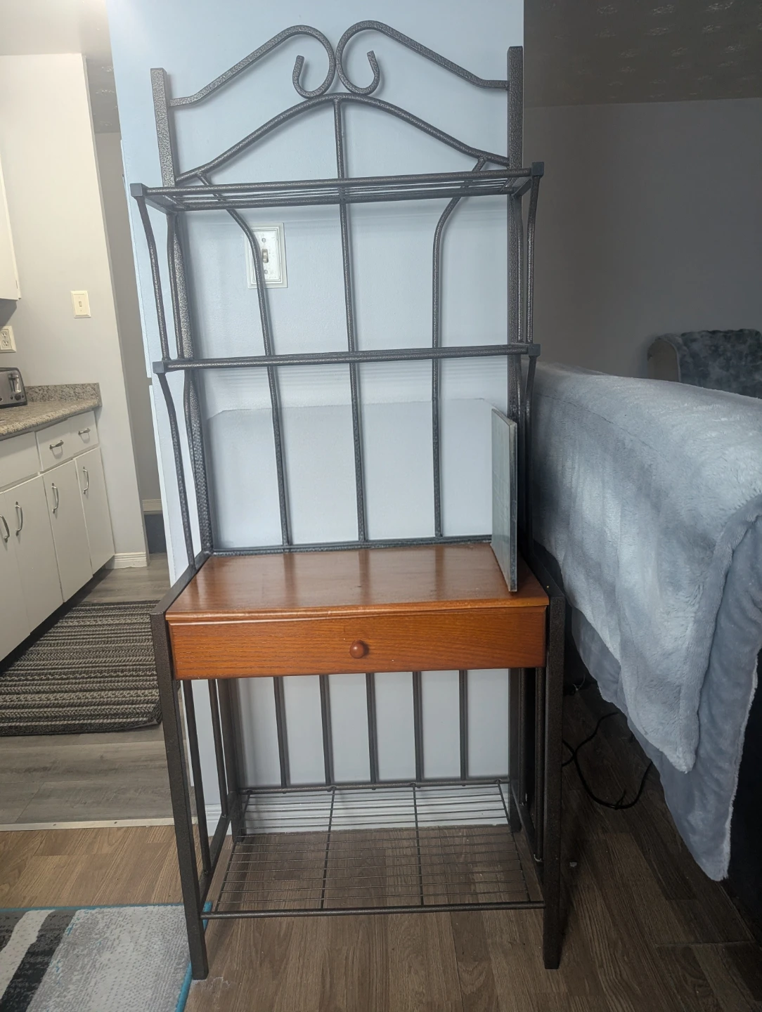 Metal bakers rack with wooden shelf and drawer