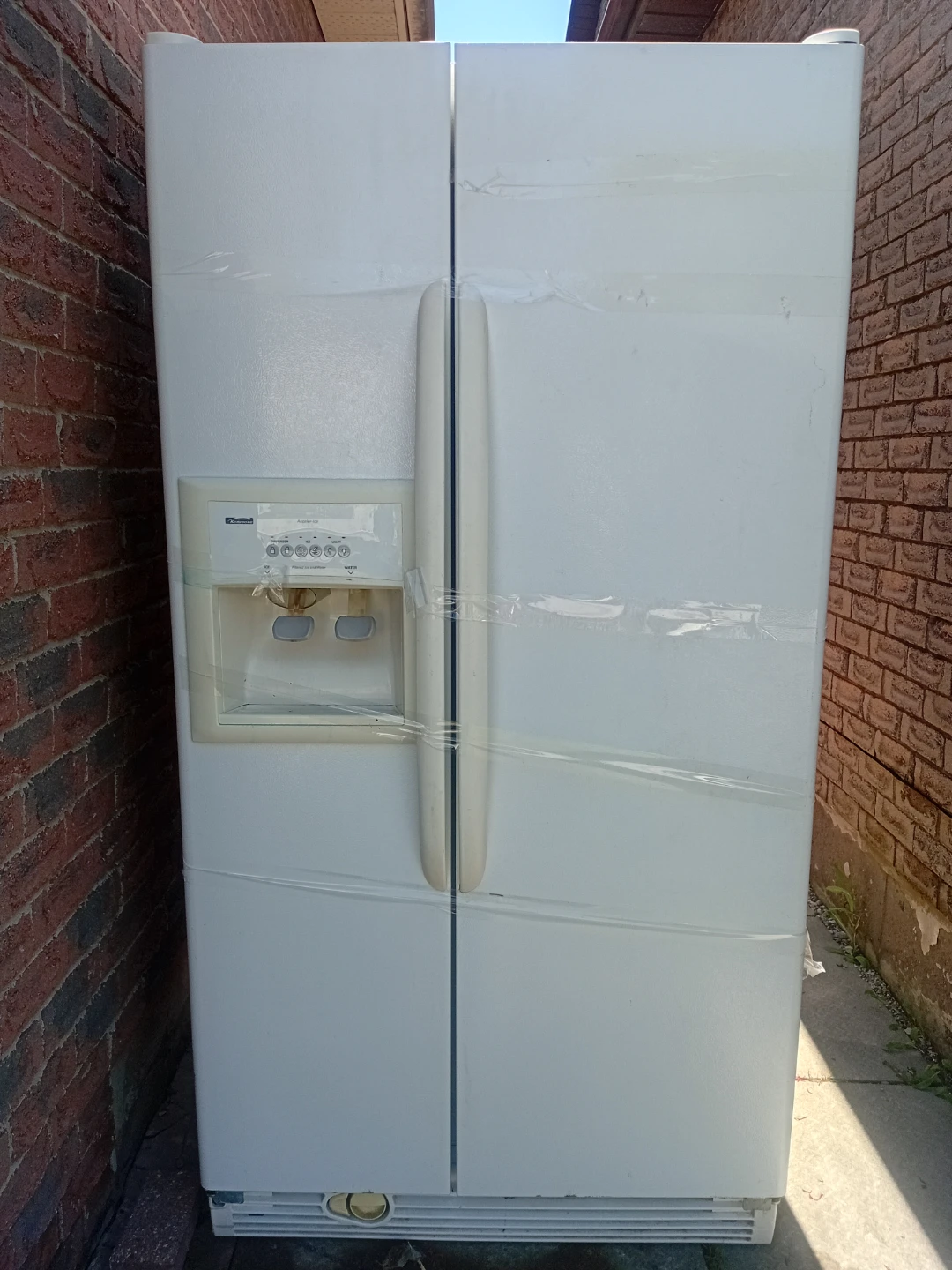 White Kenmore Side-by-Side Refrigerator with Water Dispenser