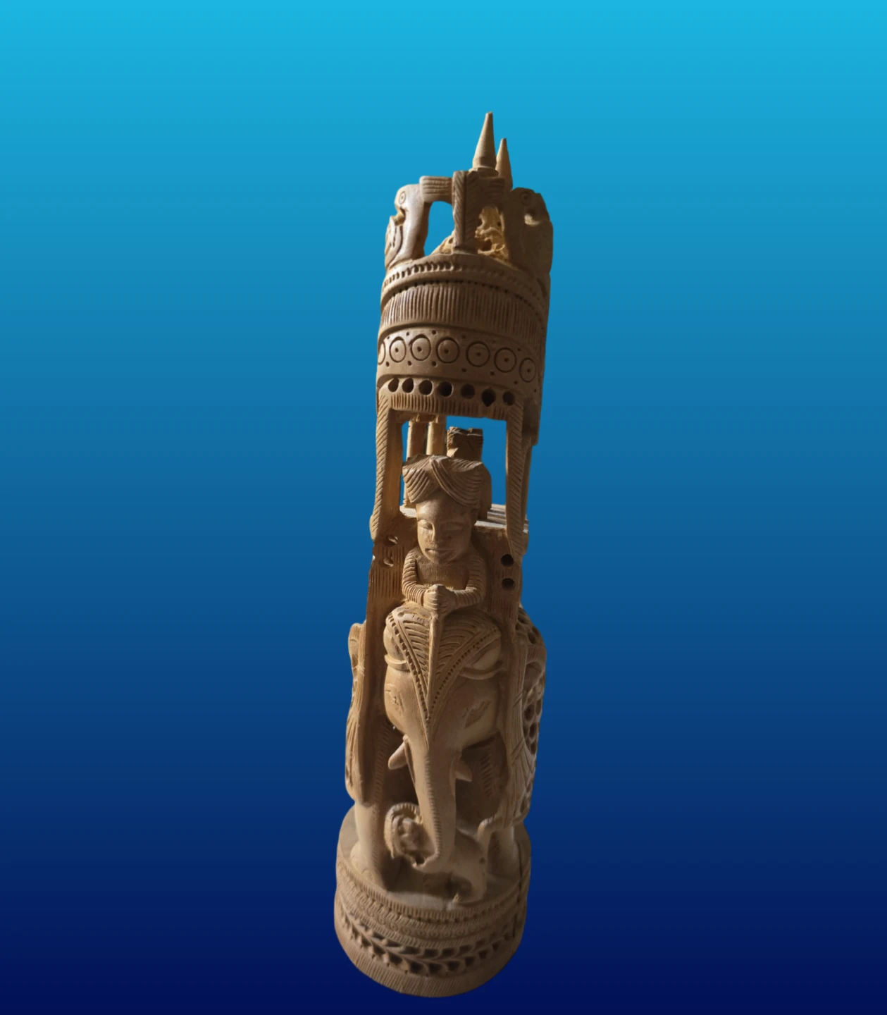 Carved wooden elephant statue with rider