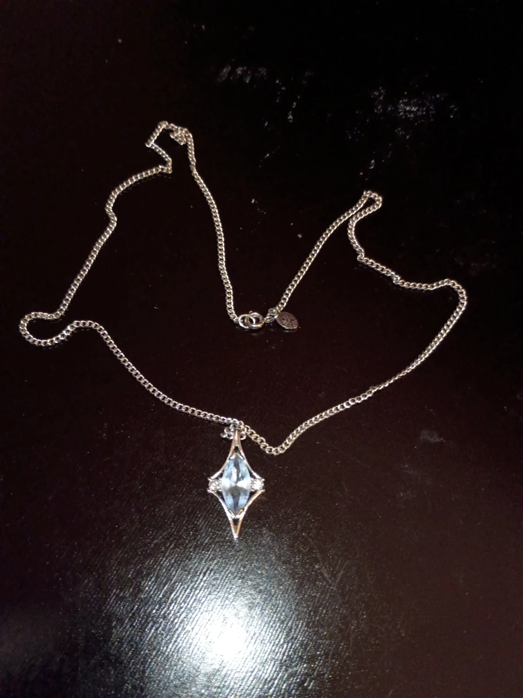 Silver tone necklace with blue crystal pendant