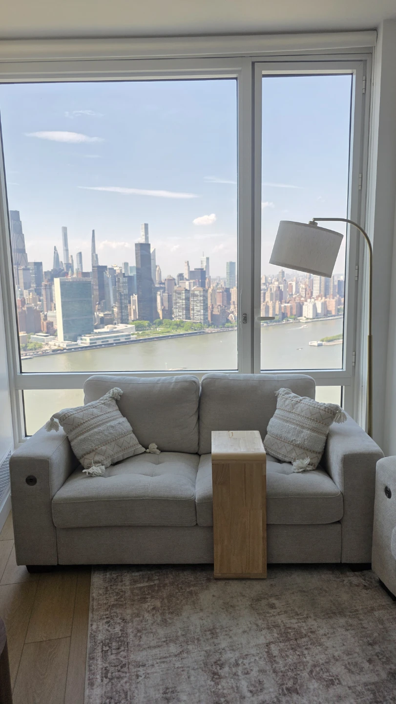 Loveseat with decor pillows, table & floor lamp.