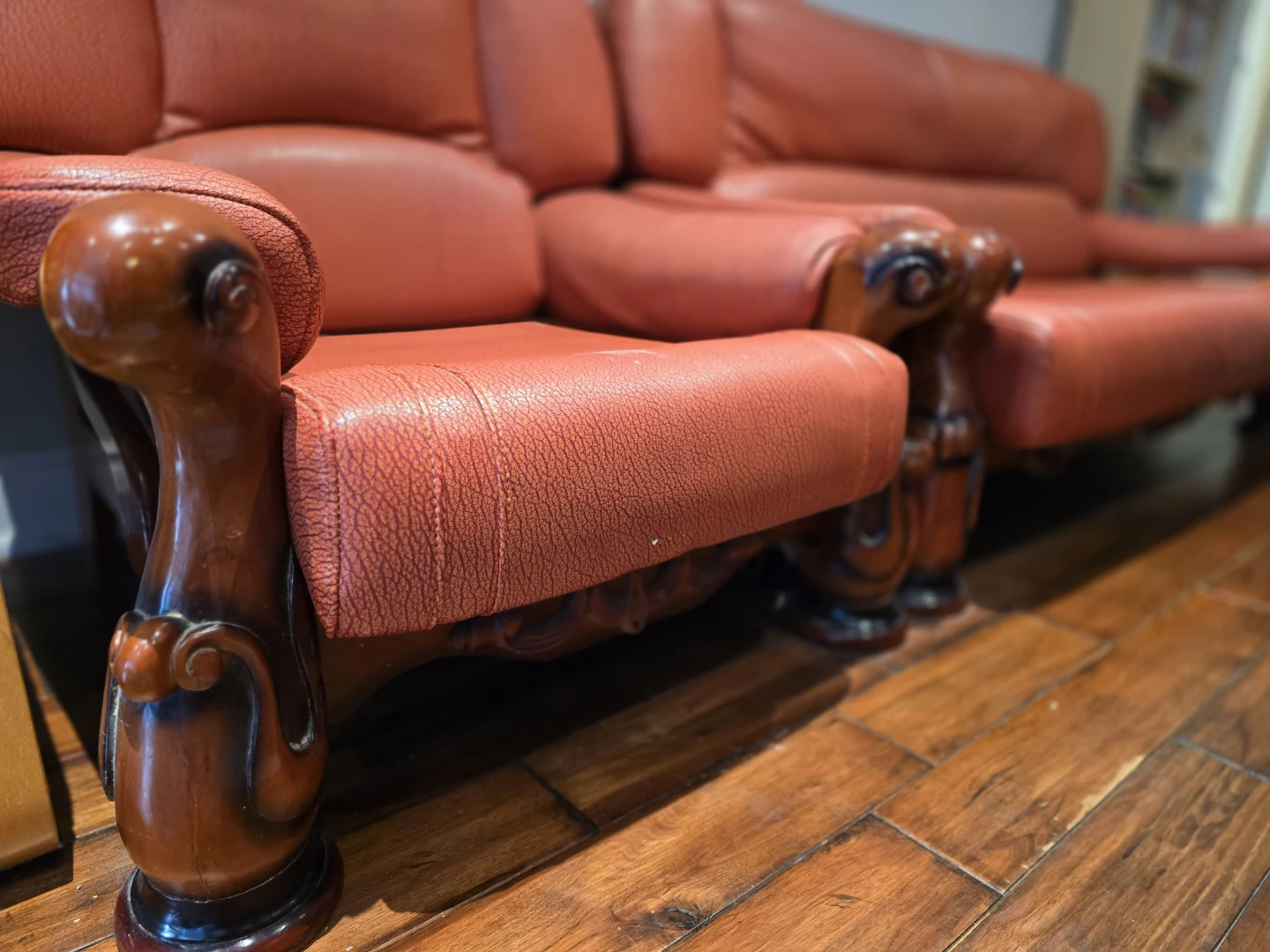 Red Leather Sofa with Wooden Accents