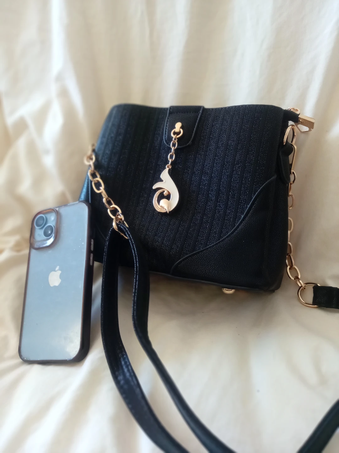 Black crossbody bag with gold accents