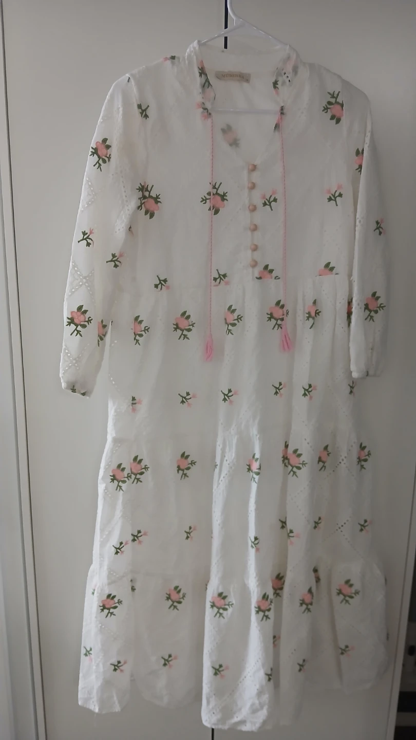White embroidered tiered dress with pink floral detail
