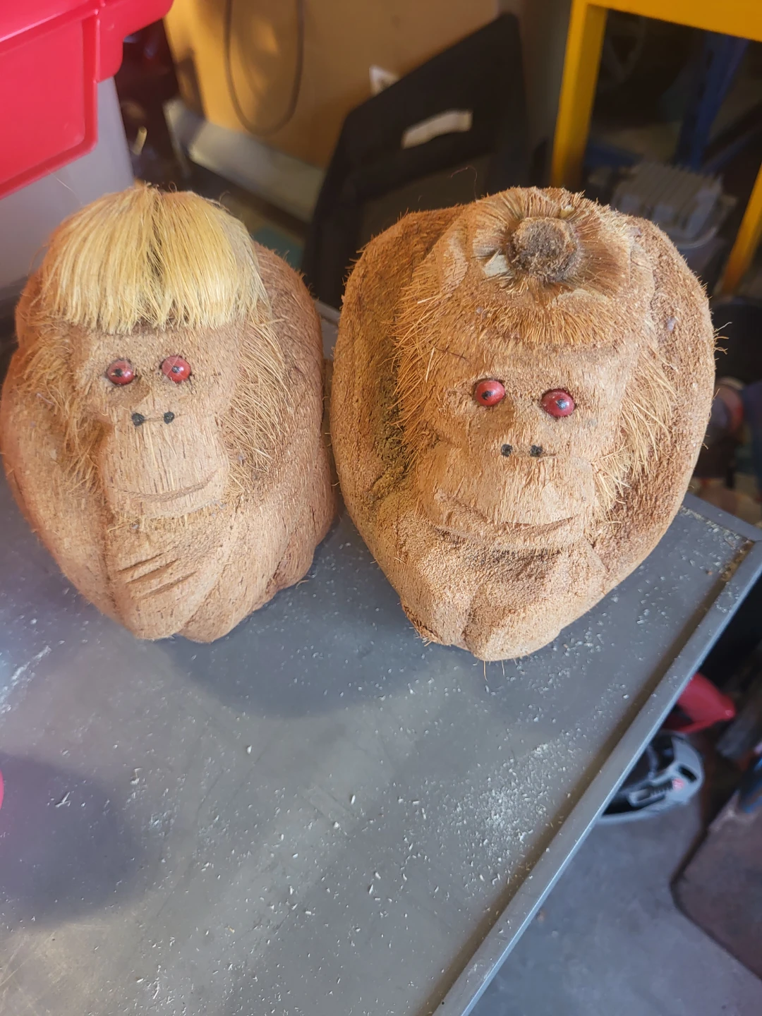 Two carved coconuts with faces