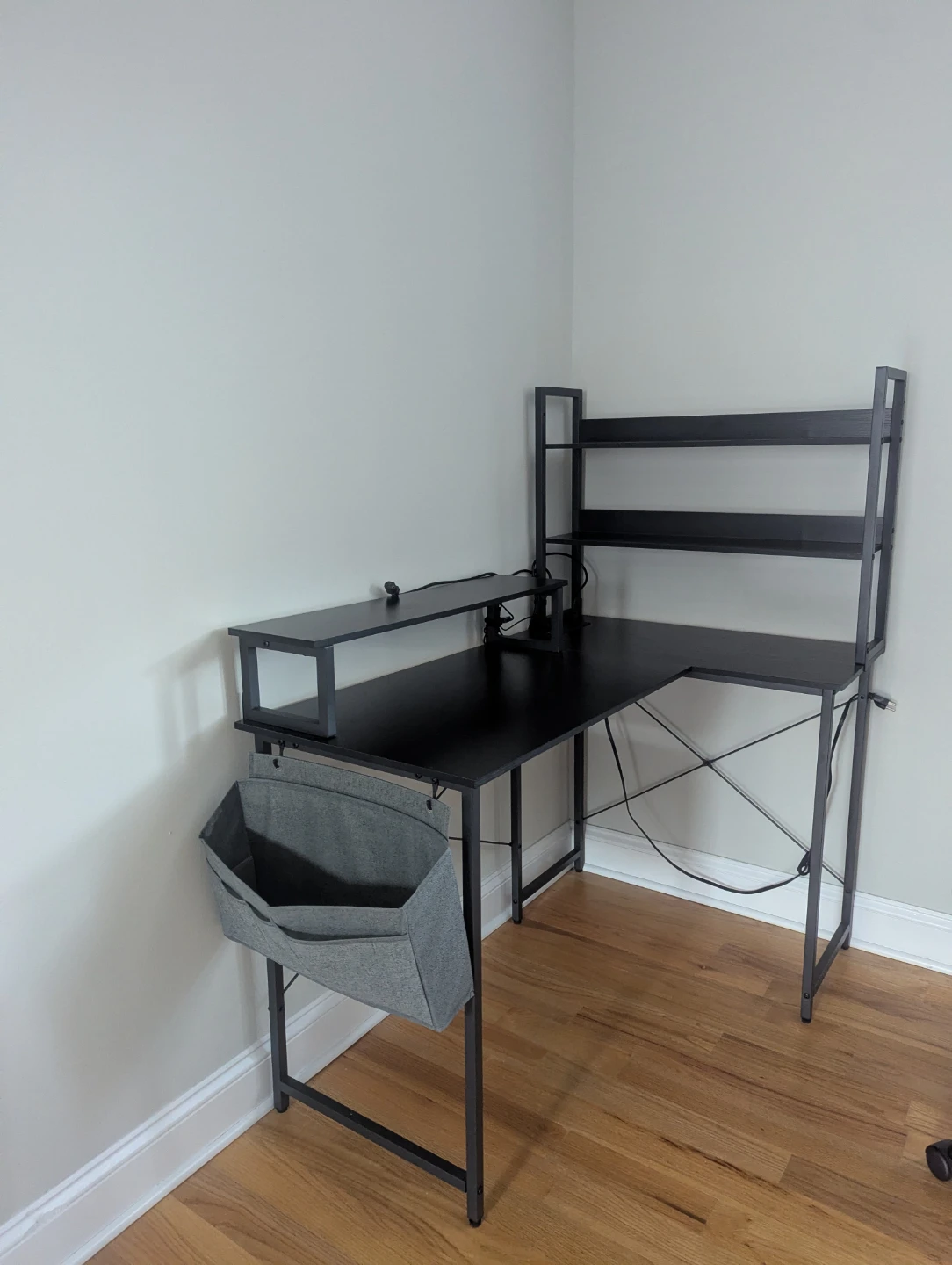 Black L-Shaped Computer Desk with Shelves and Power Outlet