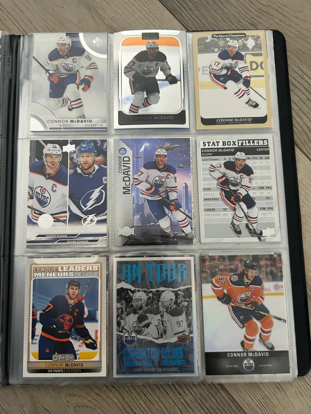 Connor McDavid hockey card collection in binder