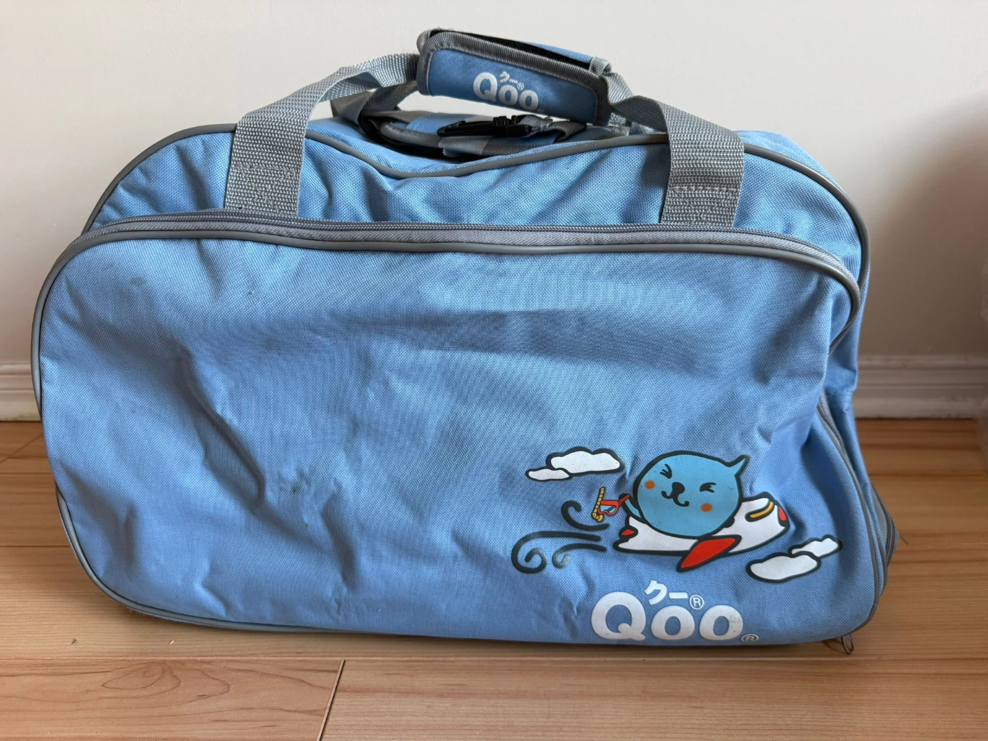 Qoo blue rolling duffel bag with cartoon character