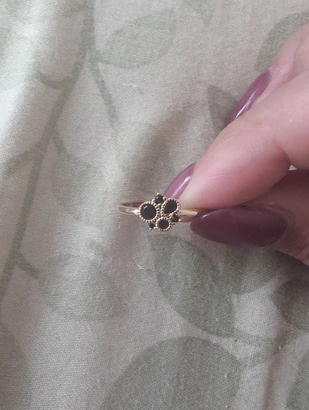 Gold-tone ring with black stones