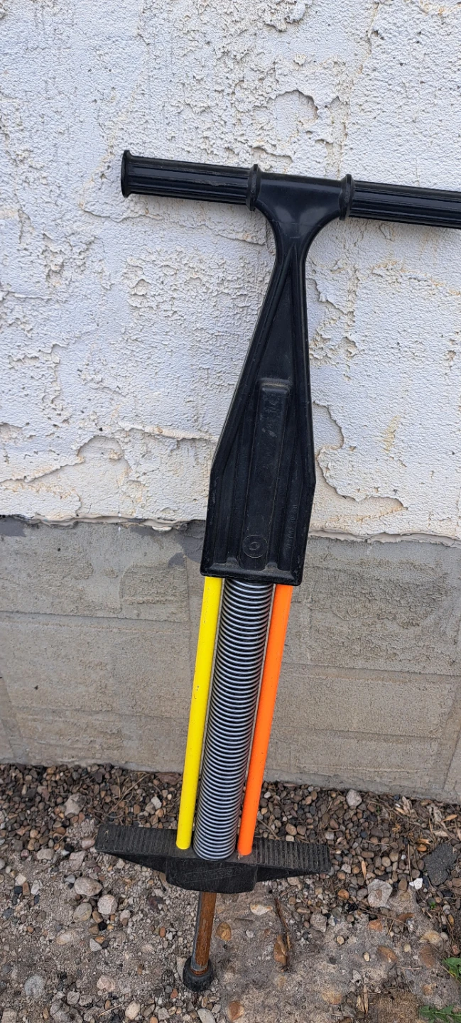 Black Pogo Stick with Yellow and Orange Accents