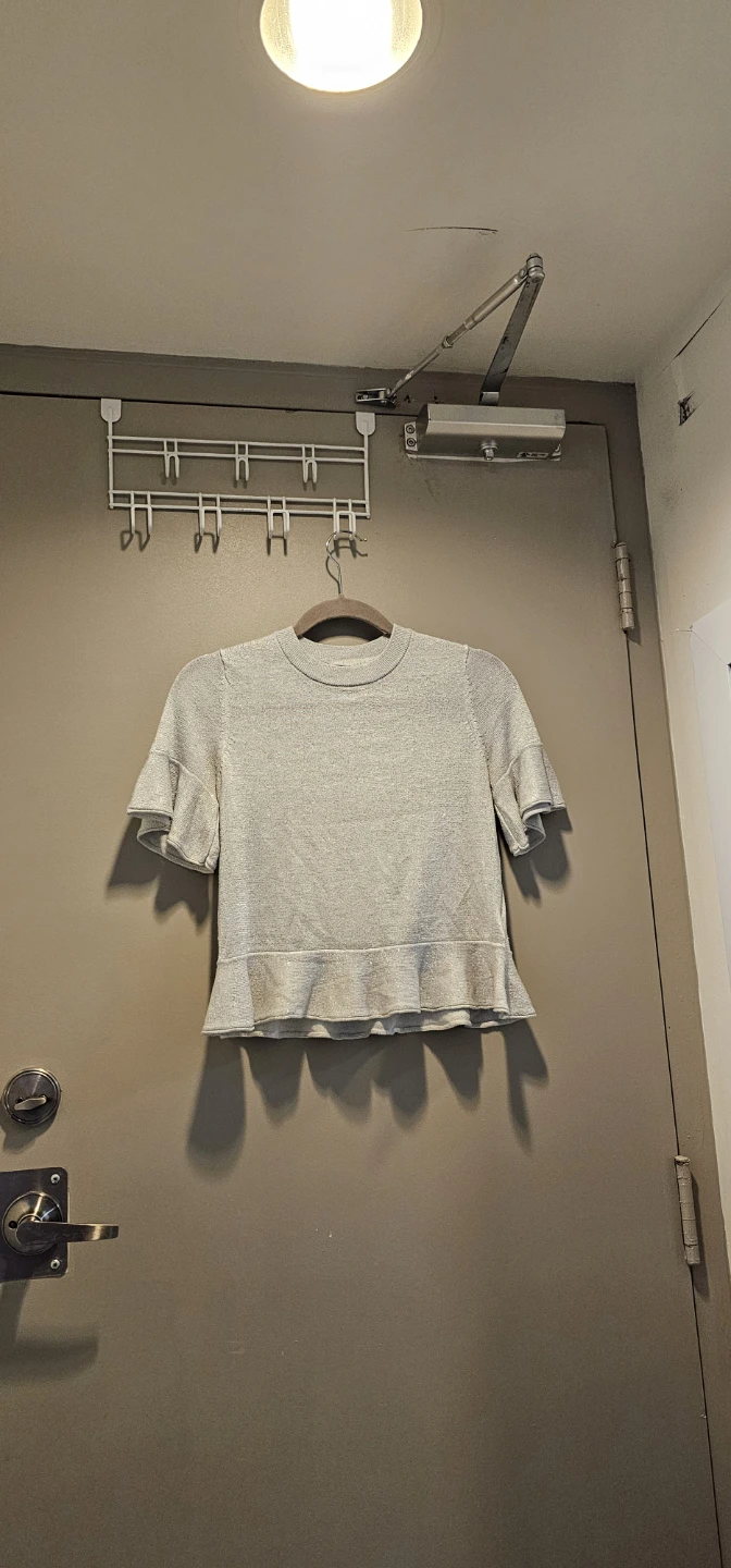 Sparkly Silver Knit Top with Ruffled Hem