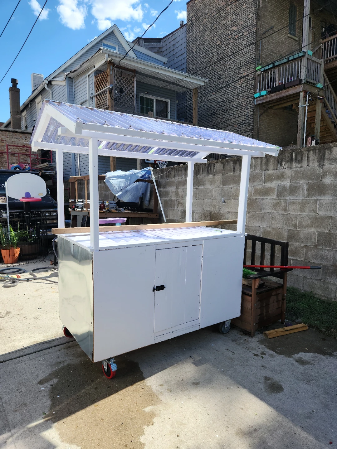 White food cart with clear roof