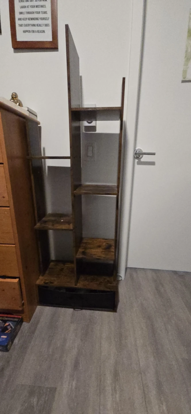 Dark brown shelving unit with bottom drawer