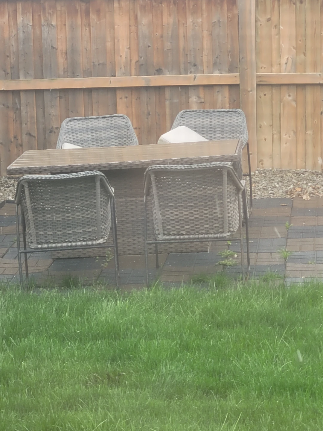 Wicker patio dining set with elevating top table and four chairs