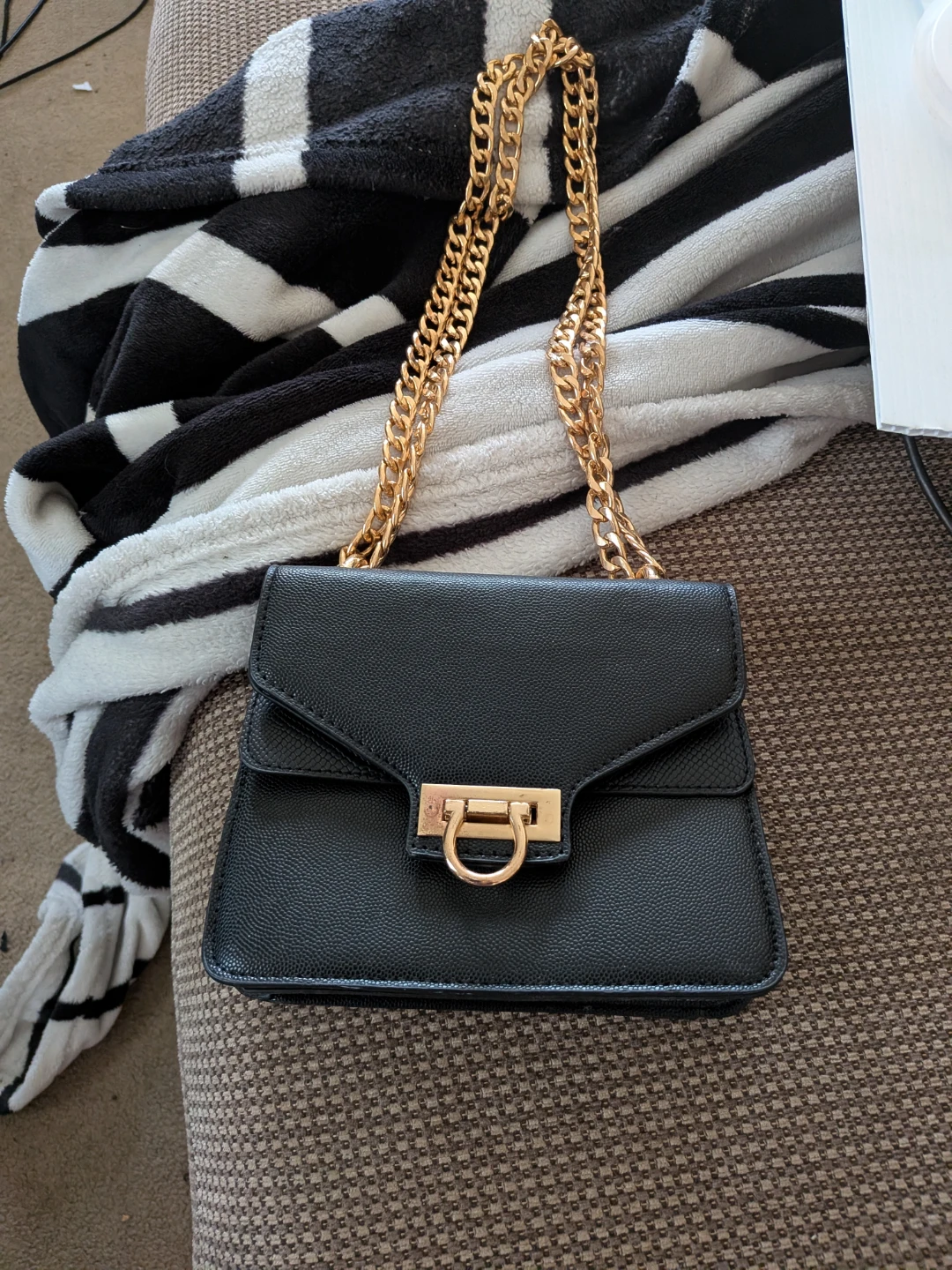 Black crossbody bag with gold chain