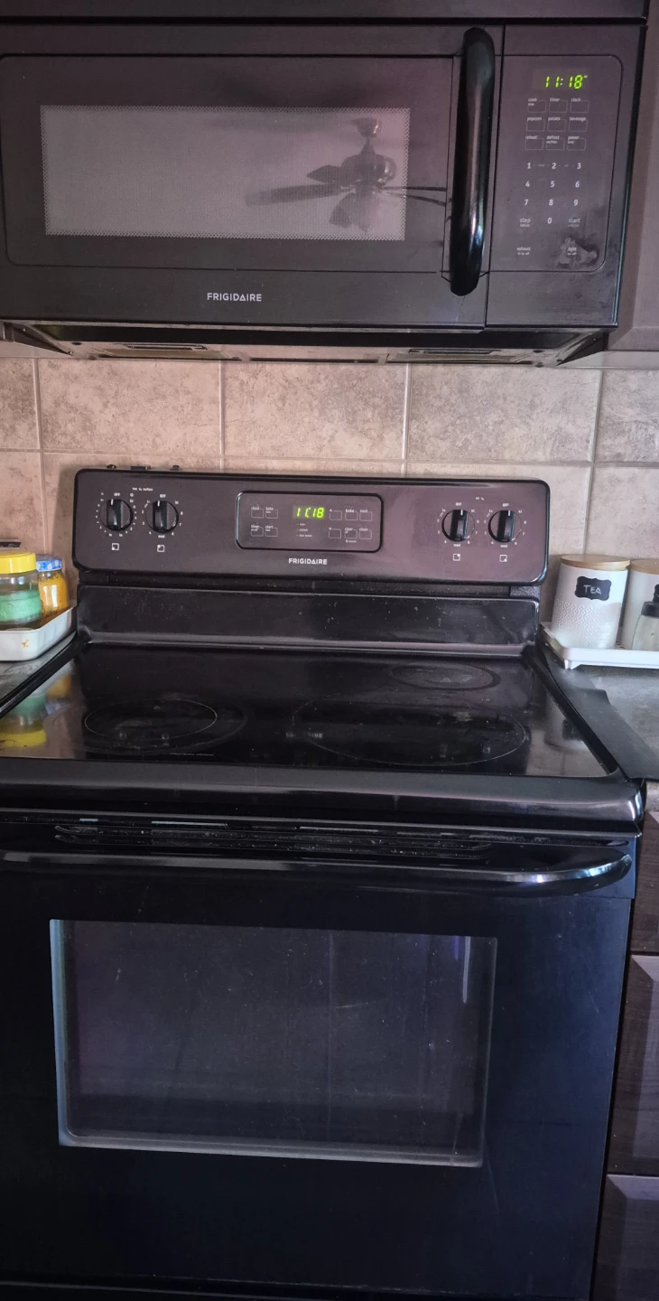 Frigidaire black stove and microwave set used