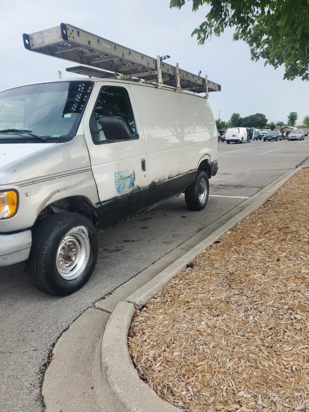 White Cargo Van with Ladder Rack