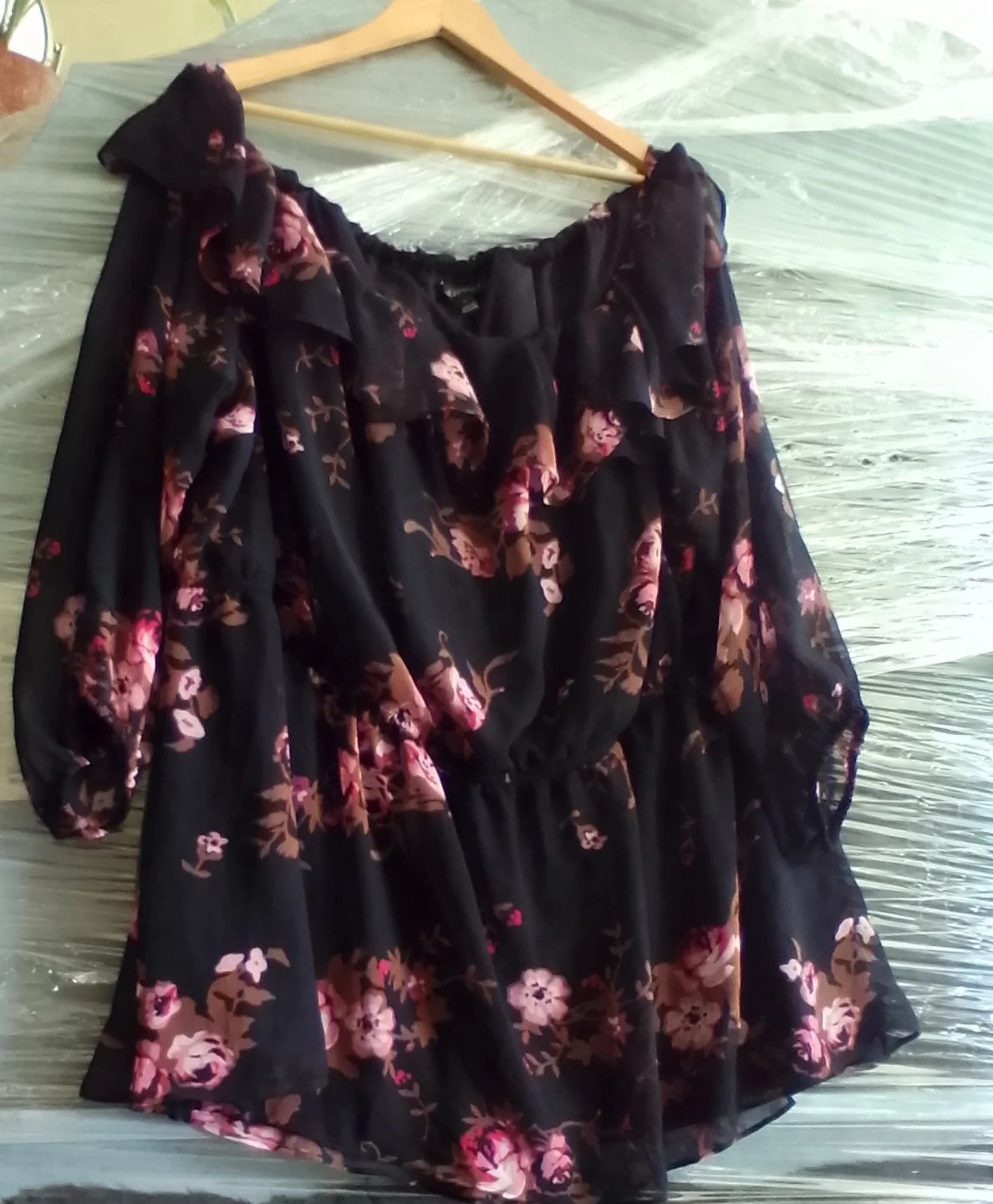 Black floral off-the-shoulder top with ruffled detail