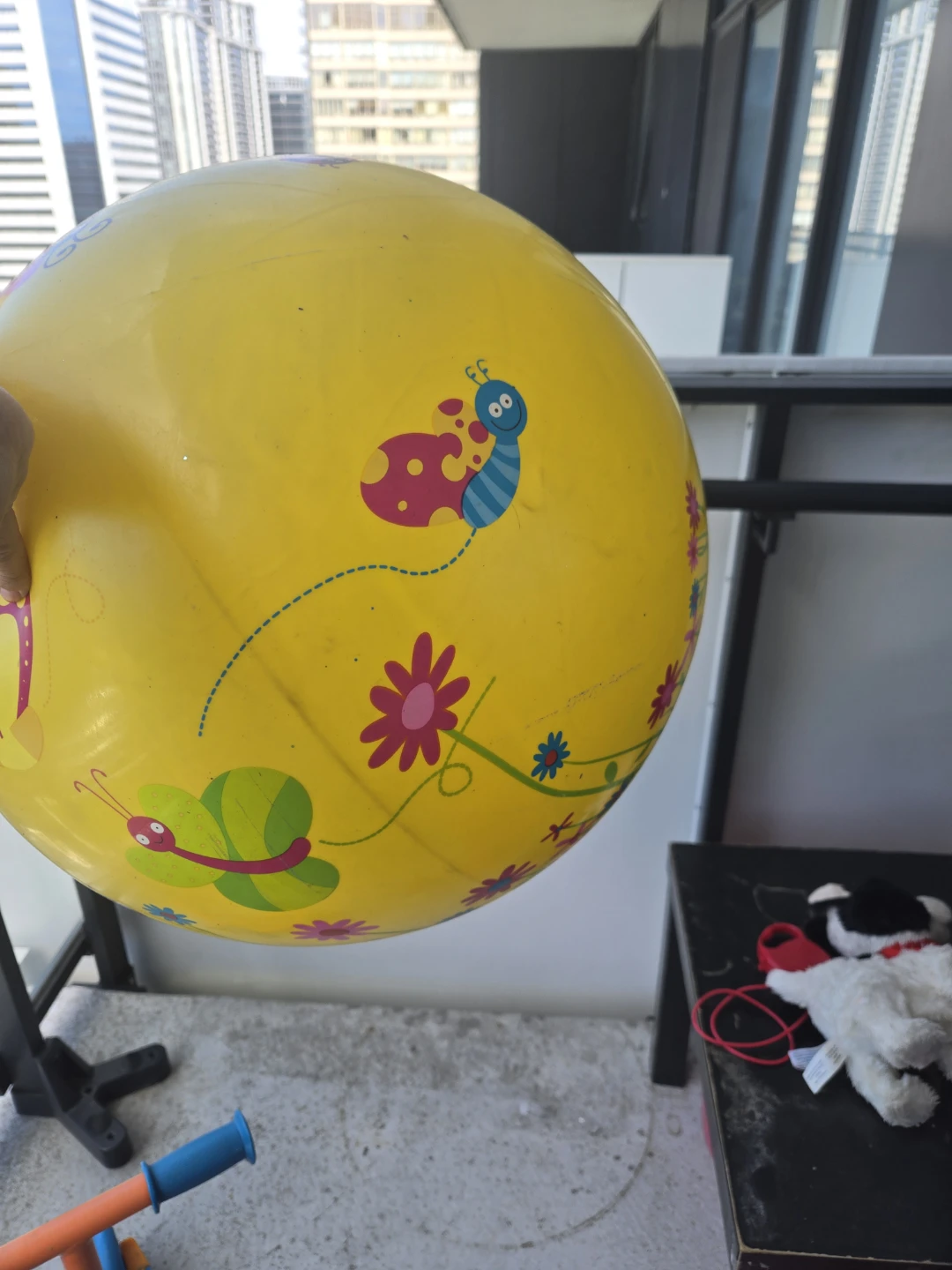 Yellow inflatable ball with bugs and flowers