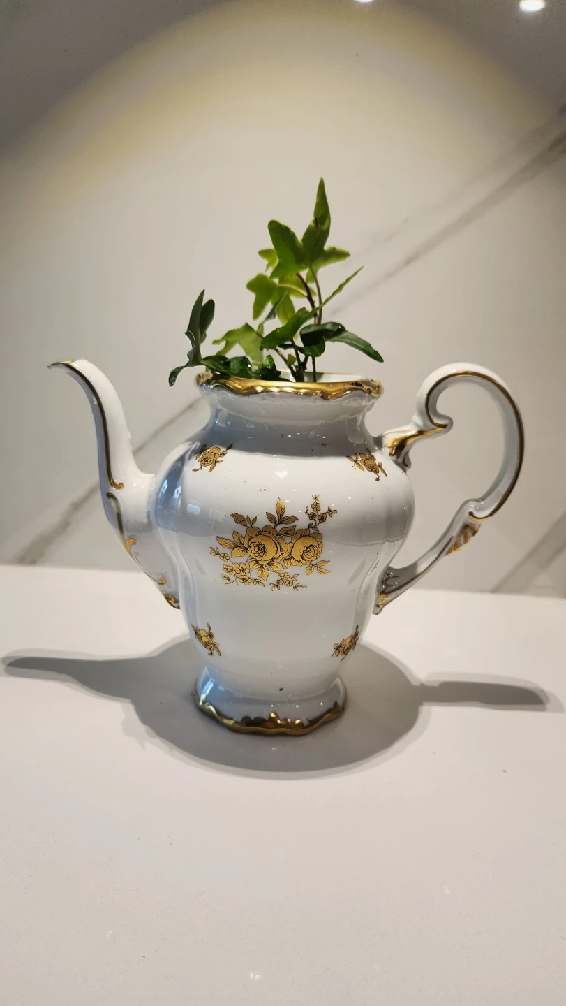 Vintage teapot planter with ivy plant