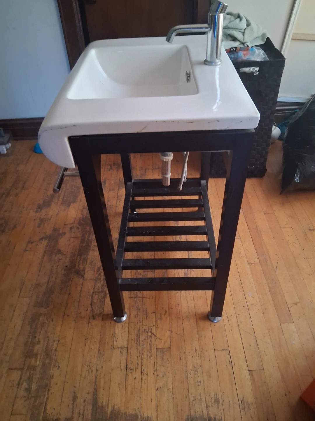 White Bathroom Sink with Black Metal Vanity Stand