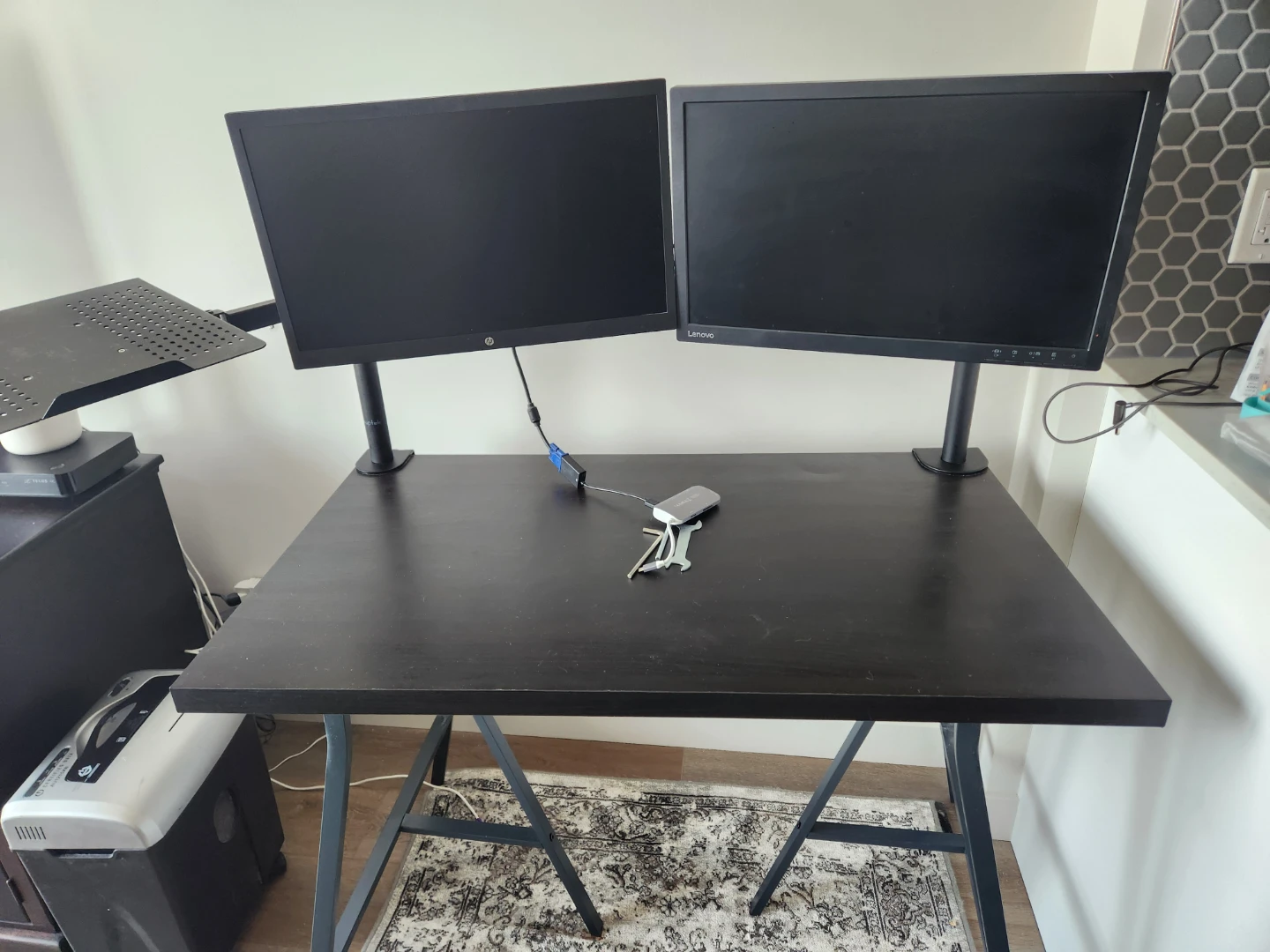 Two monitors, monitor arms, and desk