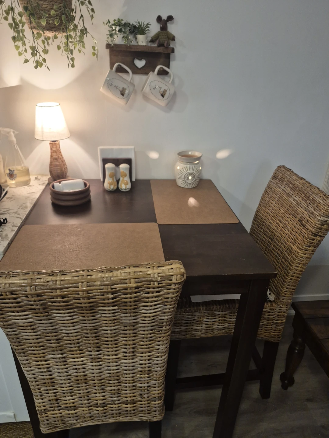 Wood dining table and wicker stools