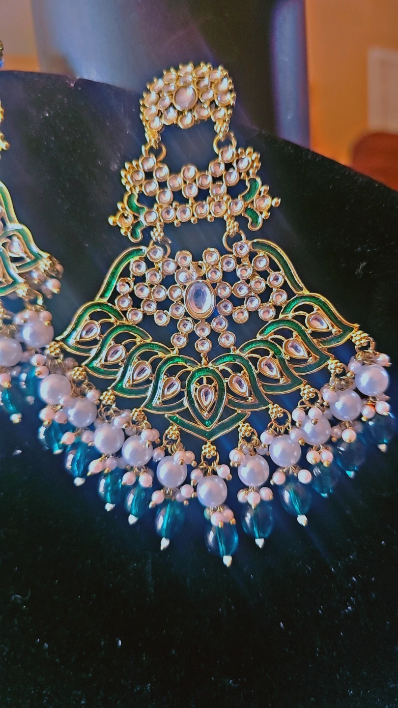 Gold-tone kundan earrings with green enamel and pearl accents