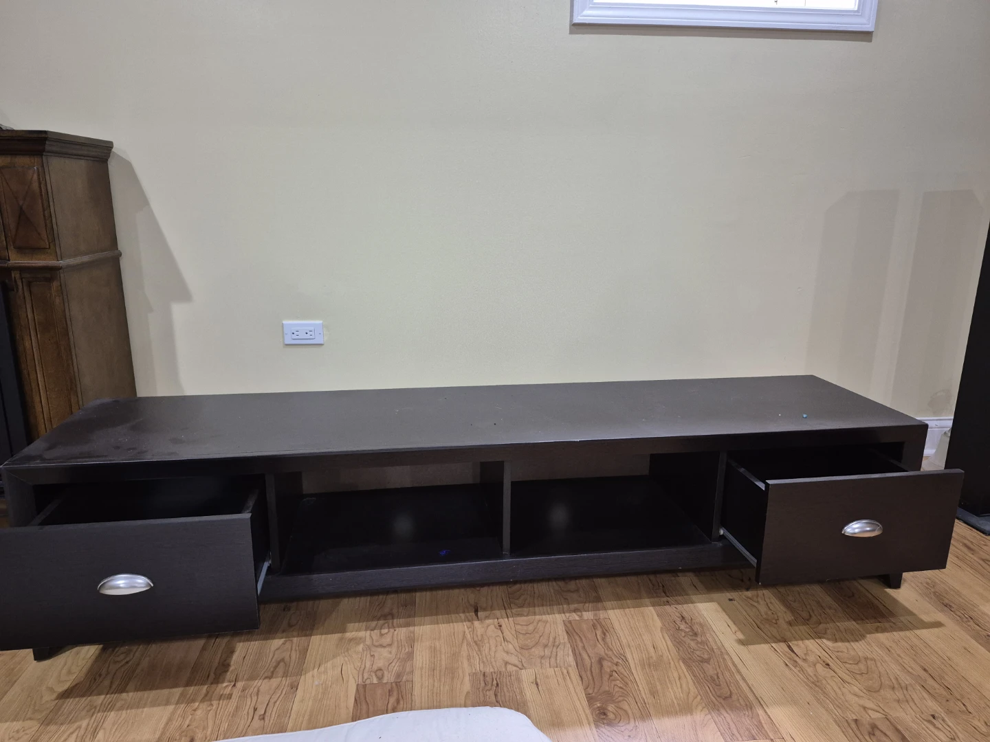 Dark brown TV stand with two drawers and open shelving.