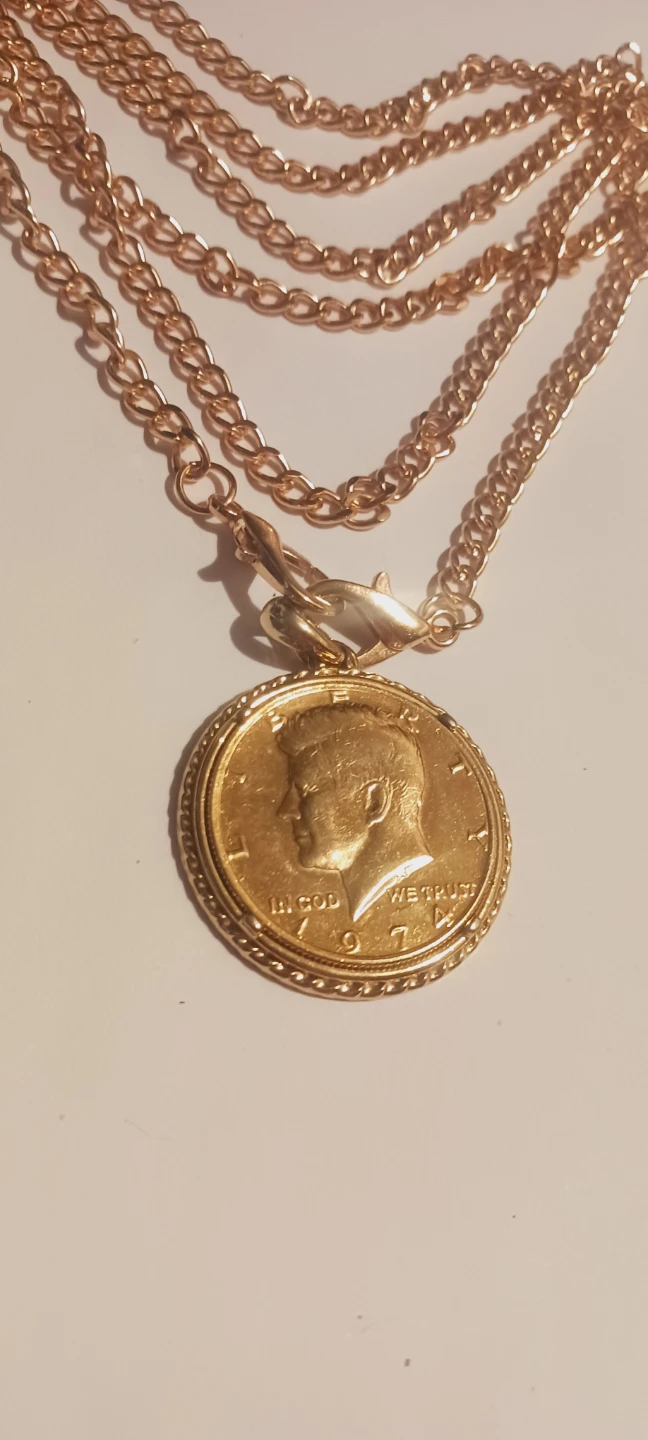 Gold tone pendant with long gold tone chain necklace