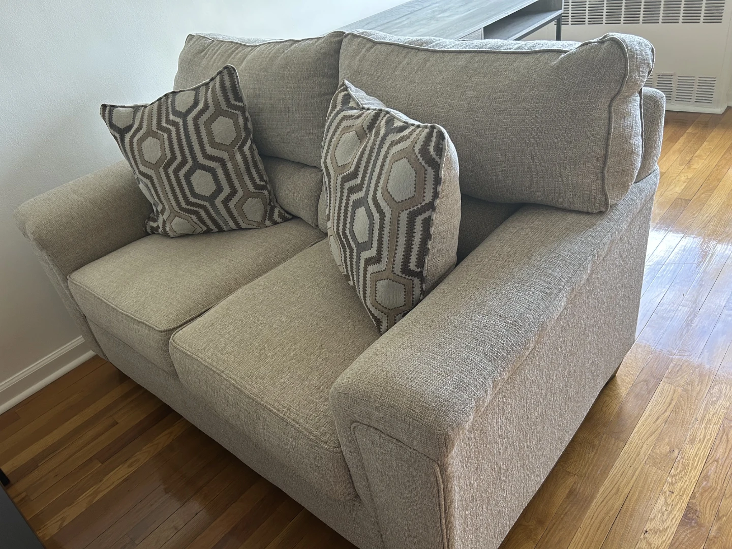 Light Beige Loveseat with Geometric Pillows
