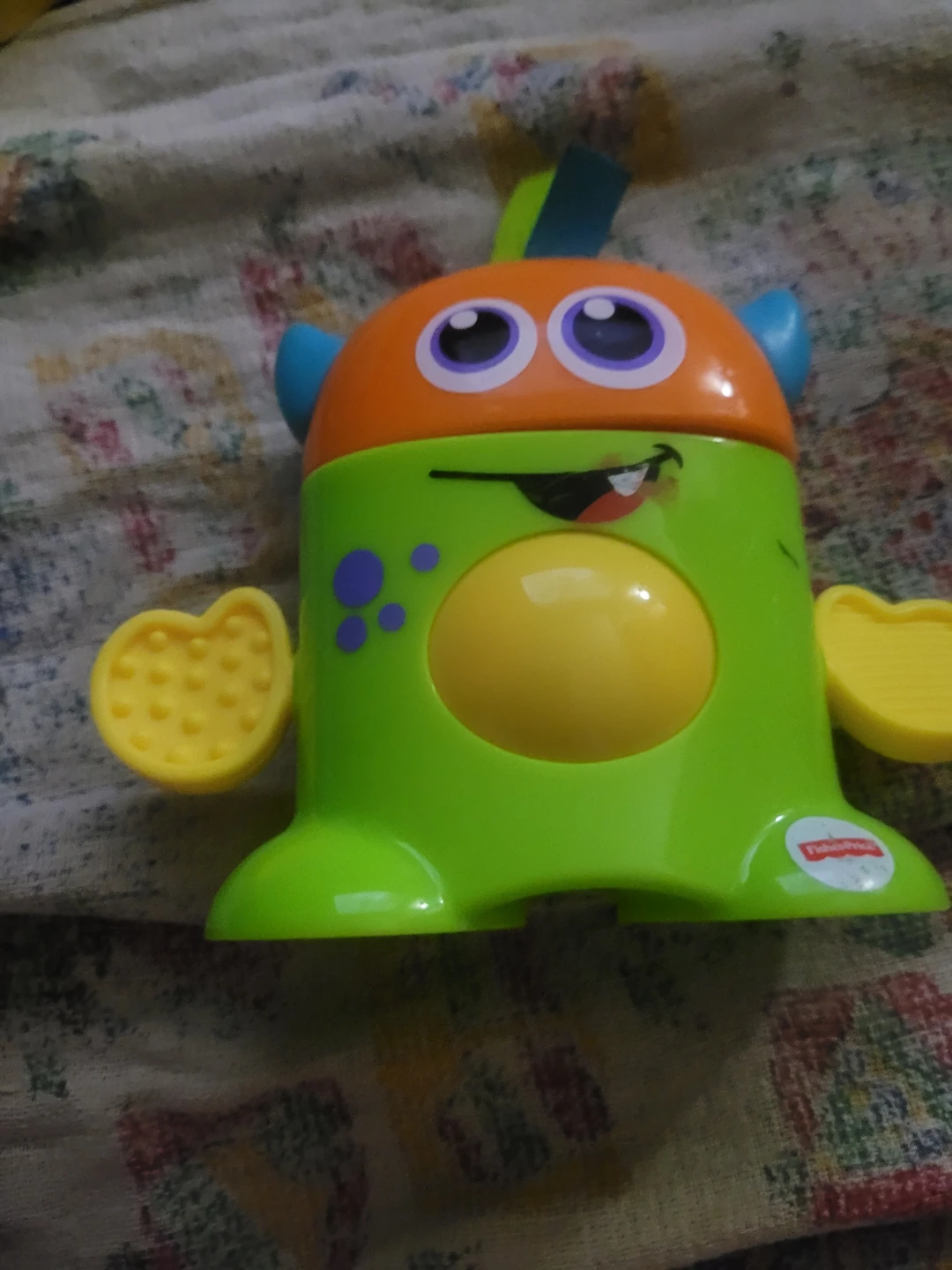 Fisher-Price Tote-Along Monsters Harvey toy in green and orange.