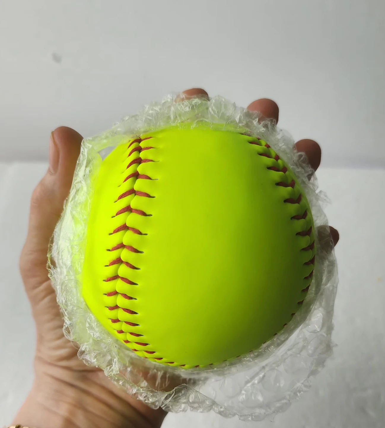 Yellow Softball with Red Stitching