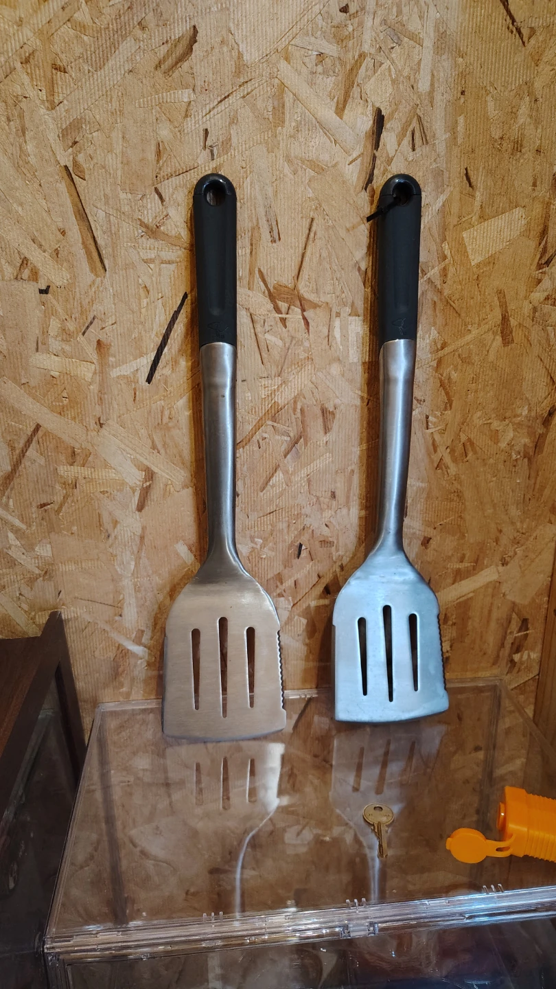 Two Stainless Steel Spatulas with Black Handles