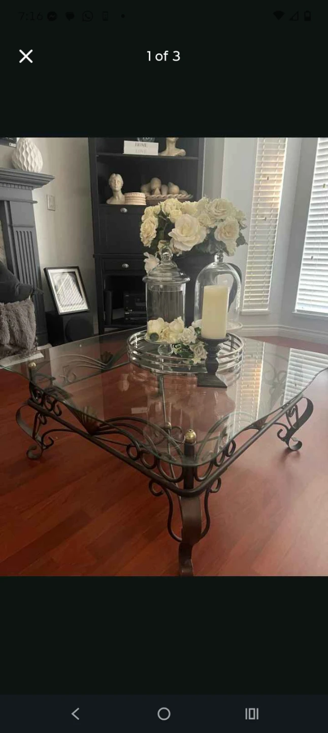 Glass top coffee table with ornate metal base