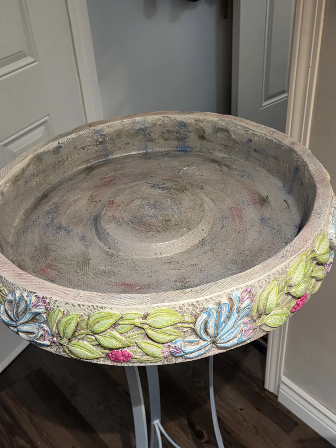 Concrete and steel birdbath.