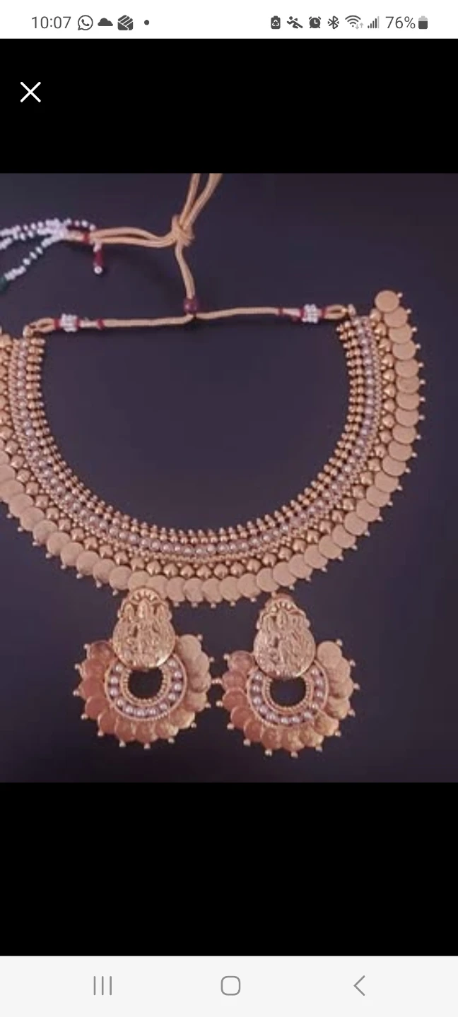 Gold colored costume jewelry necklace with earrings