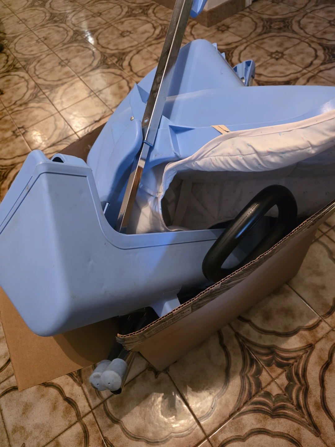 Blue infant rocker with toy bar