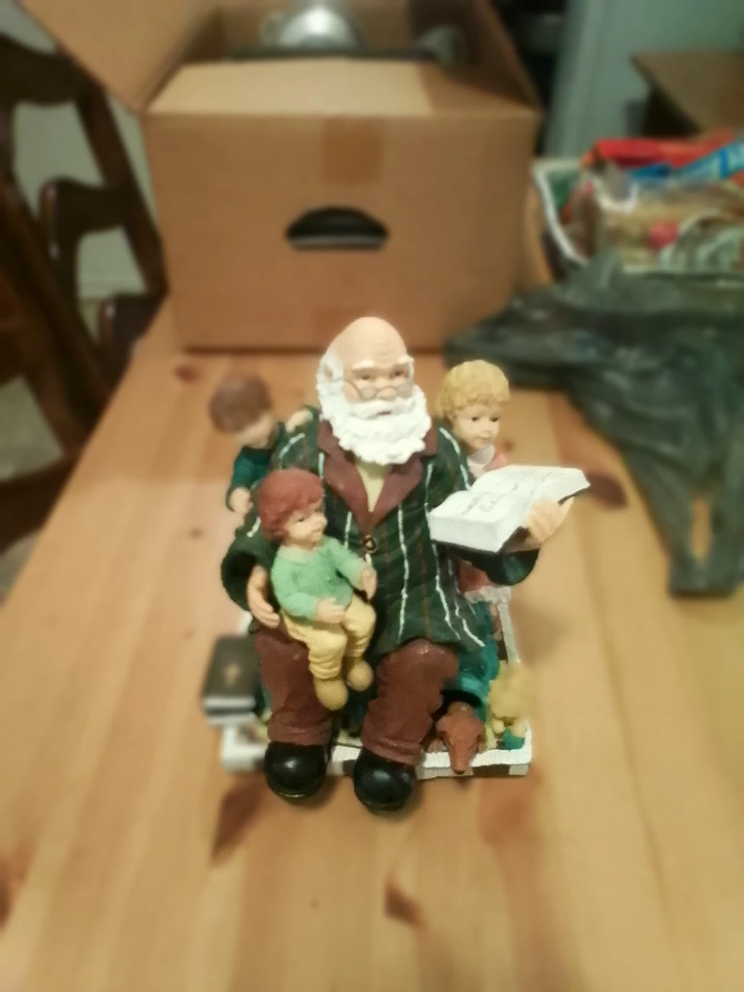 Figurine of Santa reading to children