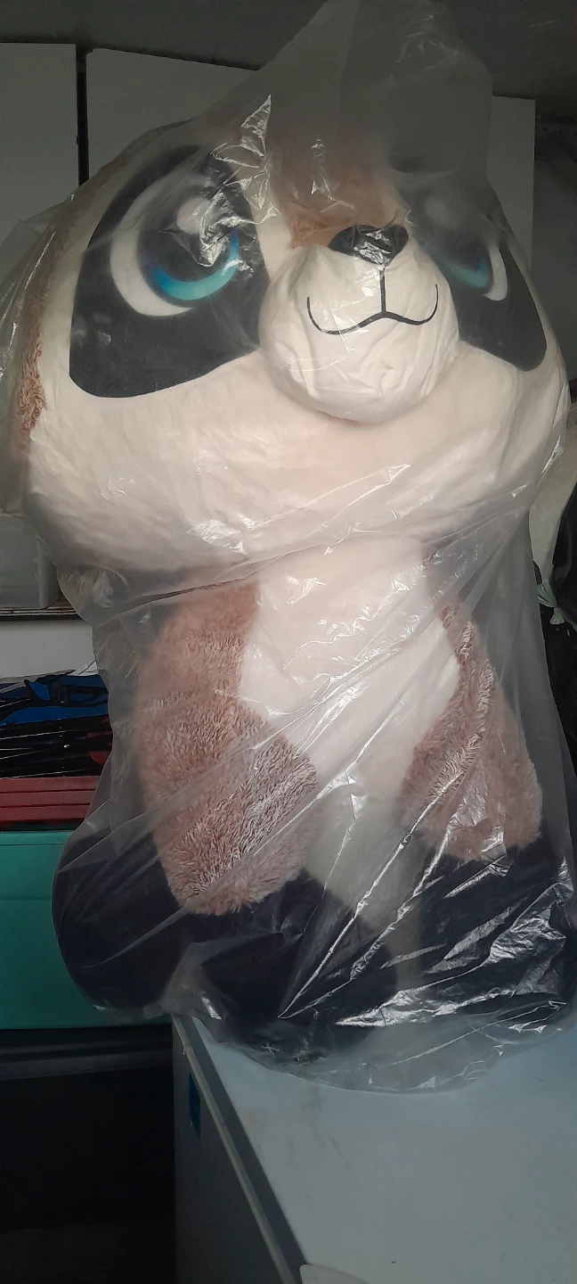 This is a large, seated meerkat plush toy.