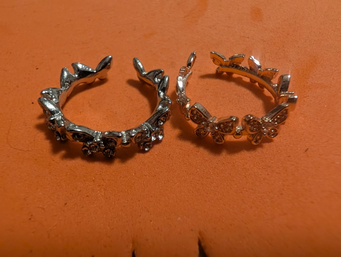 Two rings with floral and butterfly designs