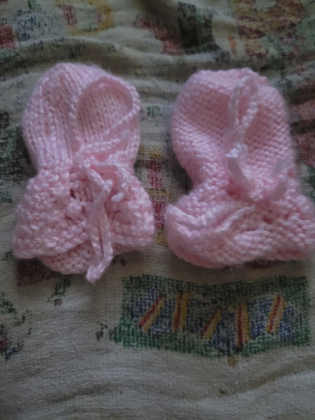 Knitted pink baby mittens