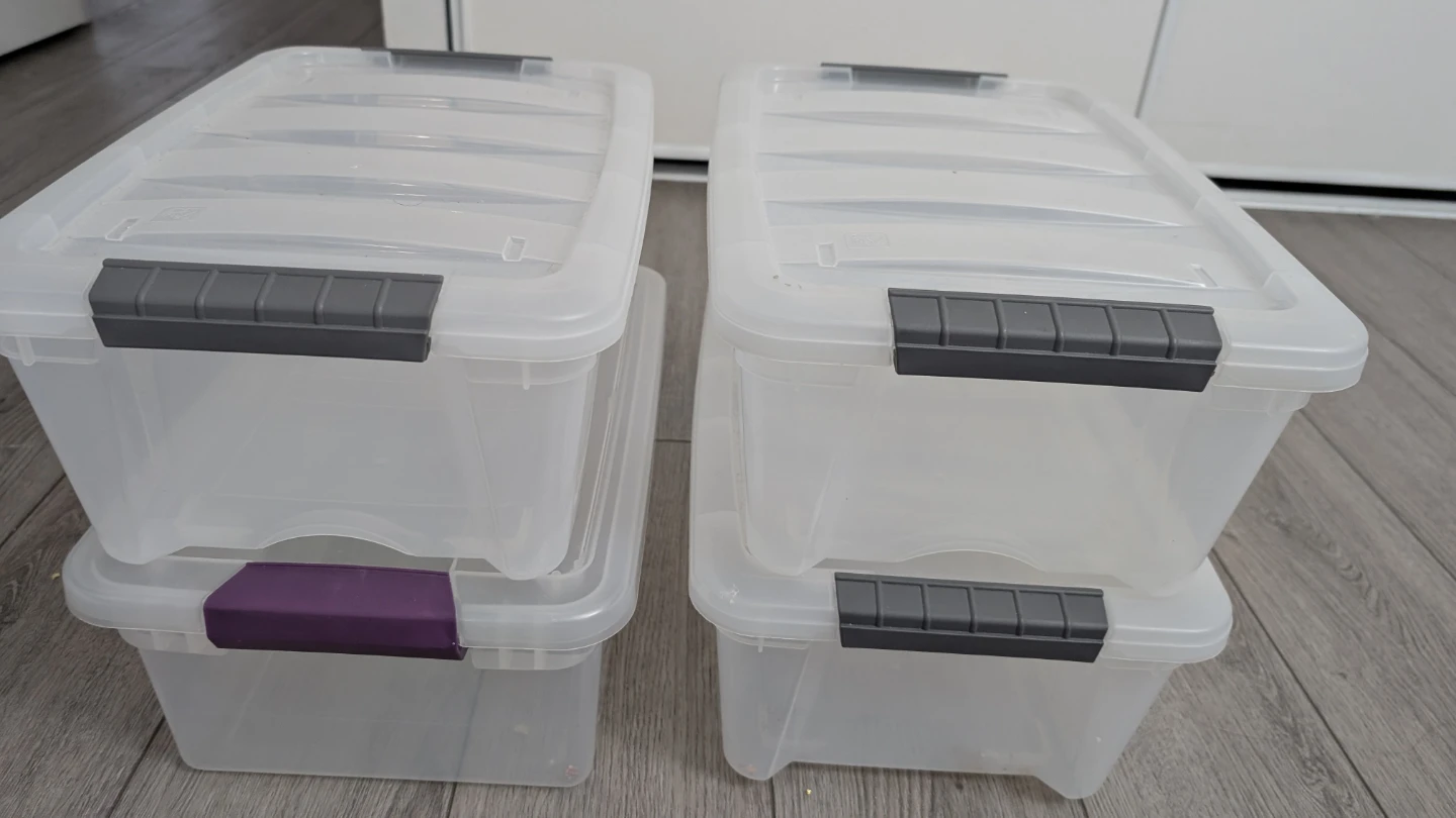 Set of 4 clear plastic storage bins with lids