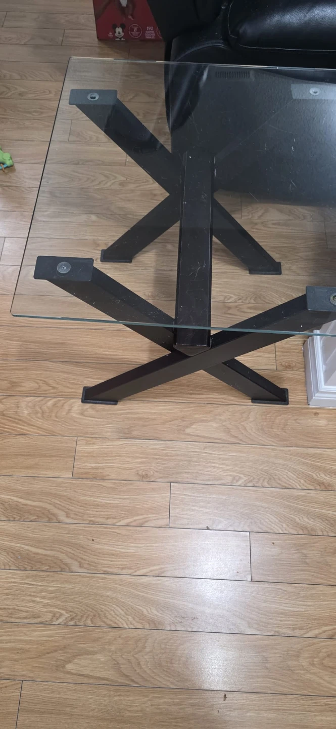 Glass coffee table with black metal base